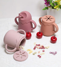 Two-in-one silicone cup demonstrating sipping and snacking features
