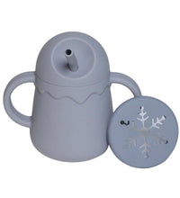 Close-up view of silicone children's cup showing no-spill lid mechanism
