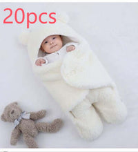 Baby quilted sleeping bag wrapper in white with bear hood, perfect for warmth and comfort, surrounded by a plush teddy bear.