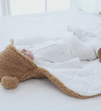 Cozy baby quilted sleeping bag wrapper with cute bear design, perfect for keeping little ones warm and snug.